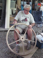 The owner - lovingly sanding the helm wheel